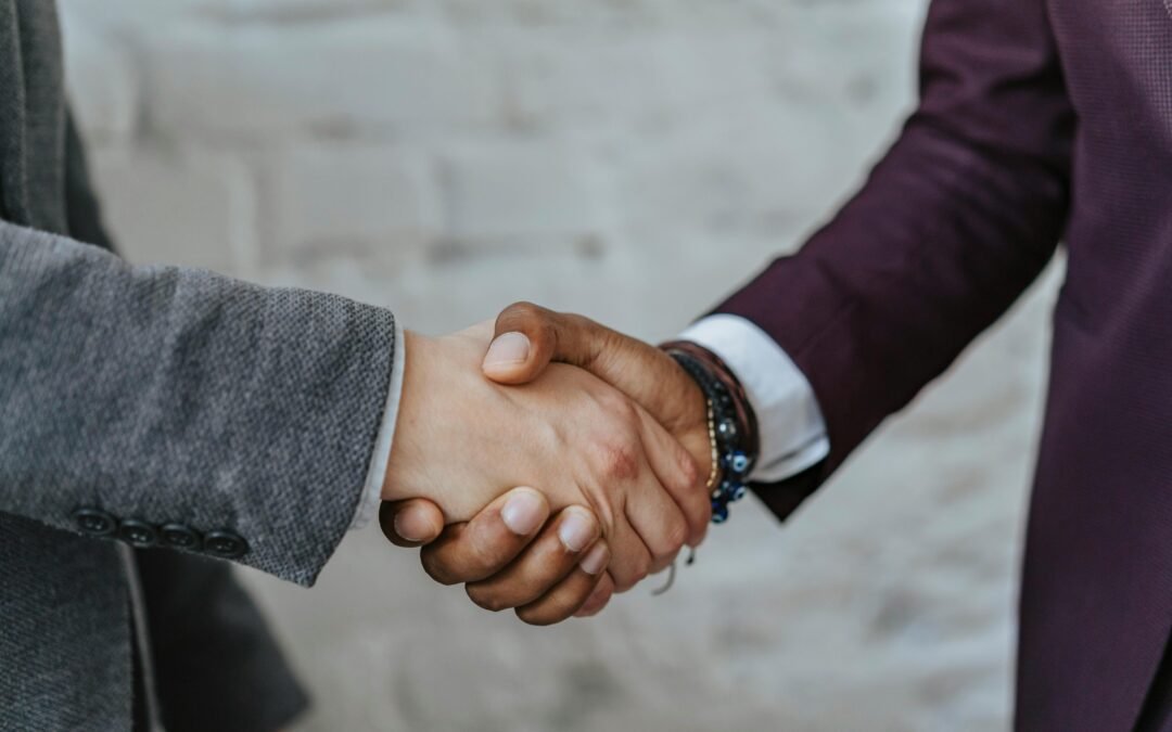 A personal injury lawyer shaking hands with a new client.