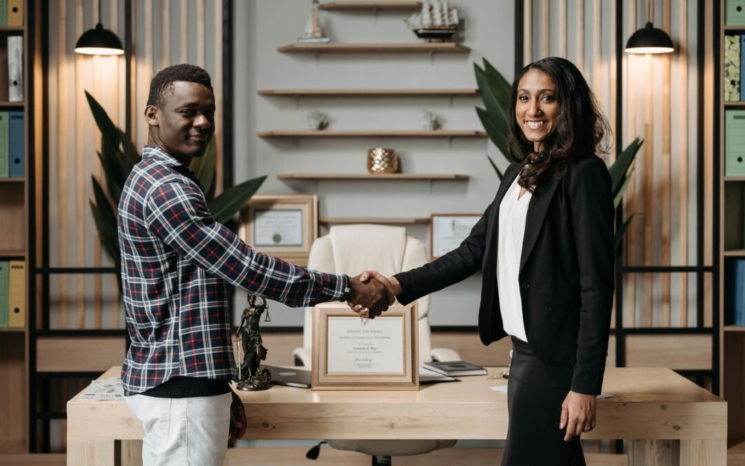 Immigration lawyer shaking hands with a new client.